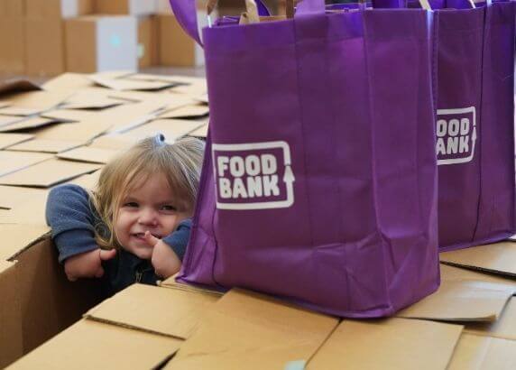 Young girl with Foodbank hamper